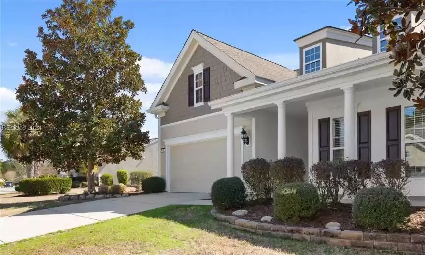 View of front of property featuring a garage and a porch