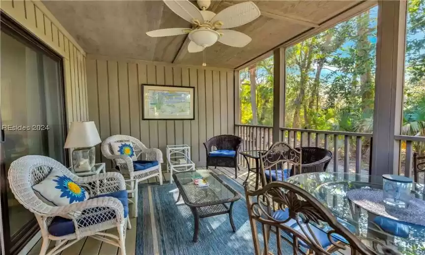Sunroom / solarium featuring ceiling fan