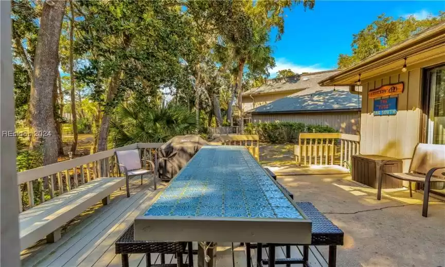 Wooden terrace featuring a patio area