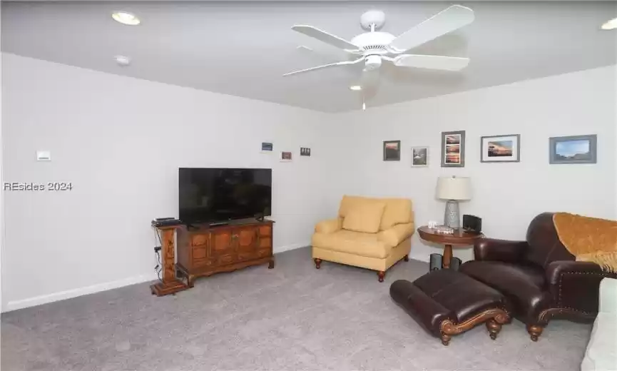 Living room featuring ceiling fan and light carpet on the 2nd (bonus room) level of the home.