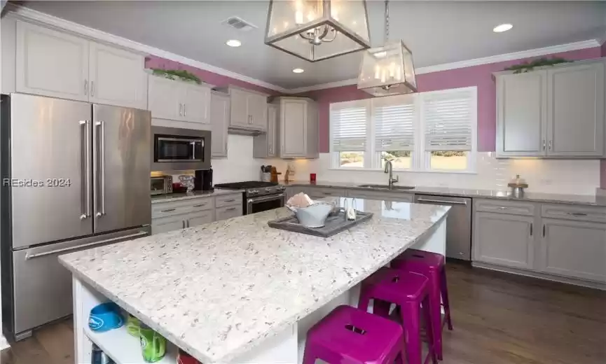 Chef's Kitchen featuring a kitchen island with book or display shelves.