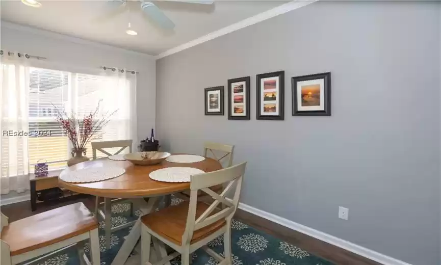 The Carolina Room can be used for casual Dining space (in addition to the seating at the island) or an extra sitting room.  It is a great space to play cards/games/or put together puzzles. It has crown molding, a ceiling fan, and manufactured wood flooring