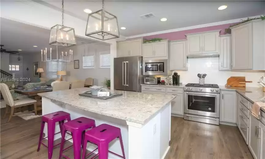 Kitchen featuring upgraded granite countertops and a natural gas range.