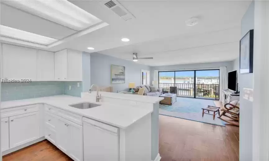 Hand scraped flooring and quartz countertops.