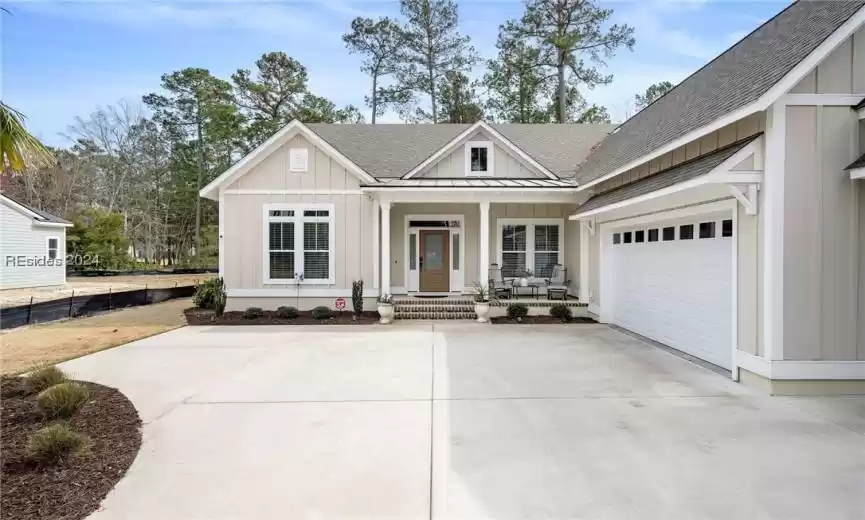 Pull up the long driveway and see the delightful front porch.