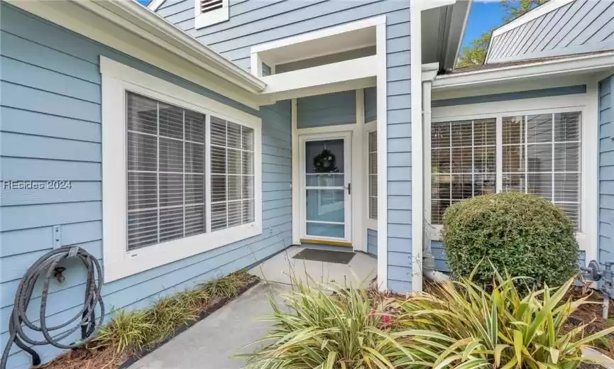 Storm Door, windows into breakfast nook and guest bedroom.