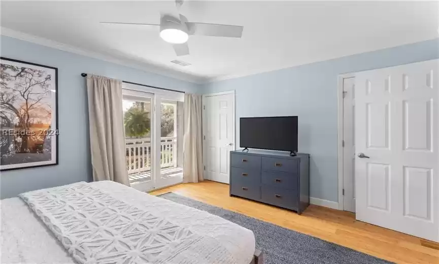 Bedroom with ornamental molding, light hardwood / wood-style floors, access to outside, and ceiling fan