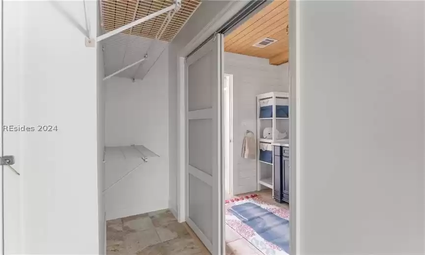 Spacious closet with light tile floors