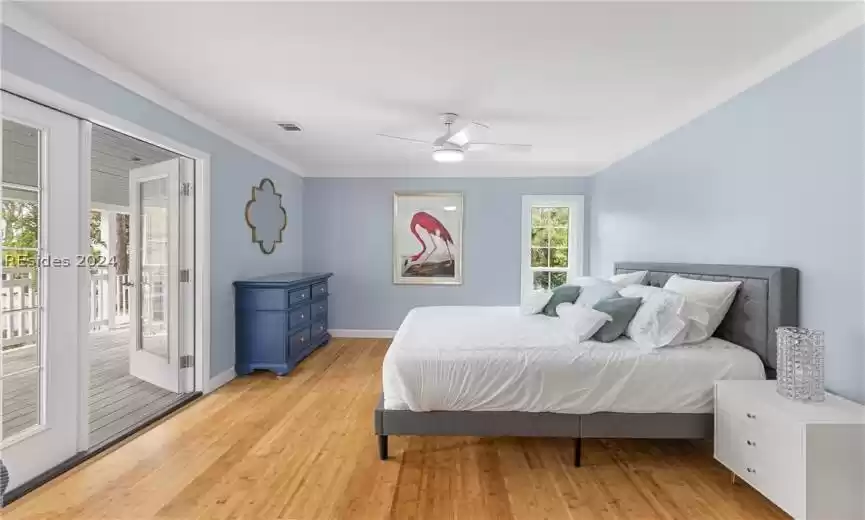 Bedroom with access to outside, light wood-type flooring, crown molding, and ceiling fan