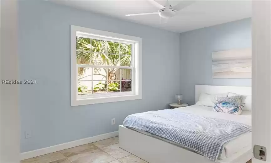 Tiled bedroom with ceiling fan