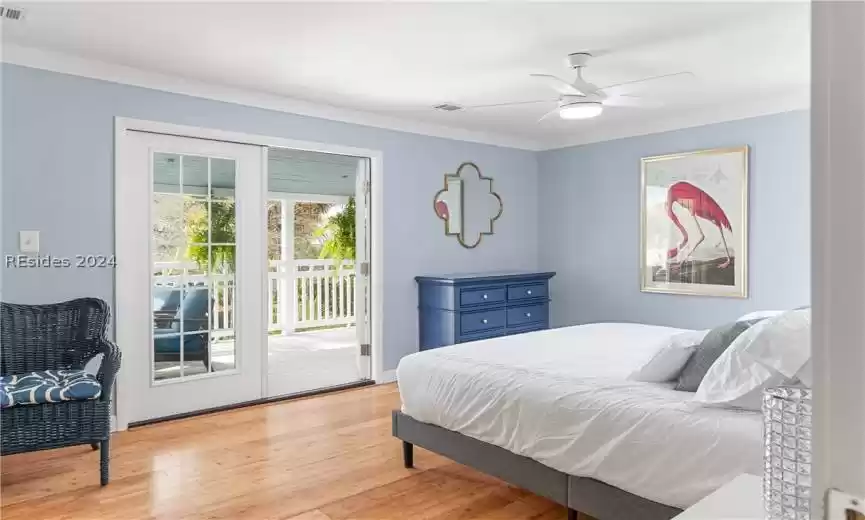 Bedroom with access to exterior, light hardwood / wood-style flooring, and ceiling fan