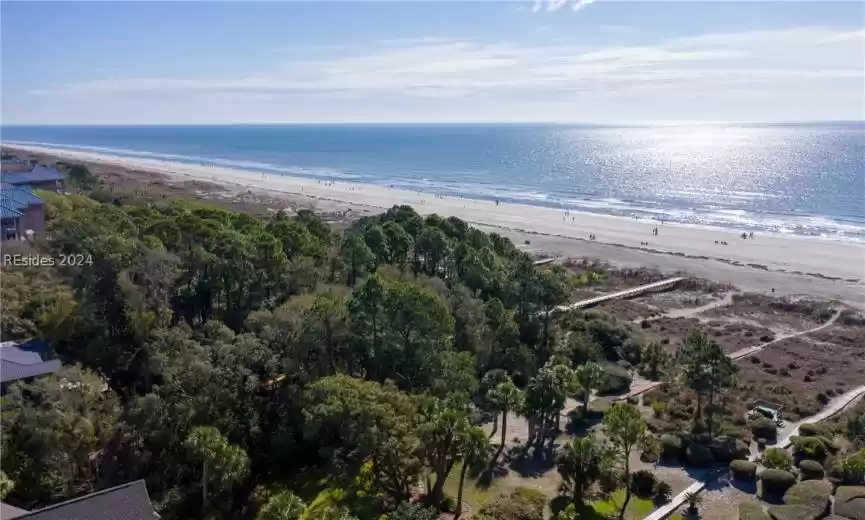 Birds eye view of property with a beach view and a water view