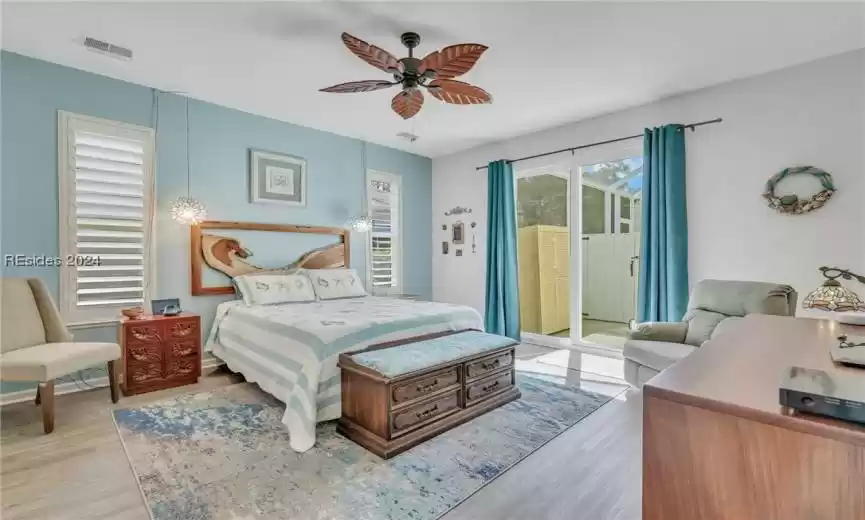 Primary bedroom with sliders going out to screened heated pool