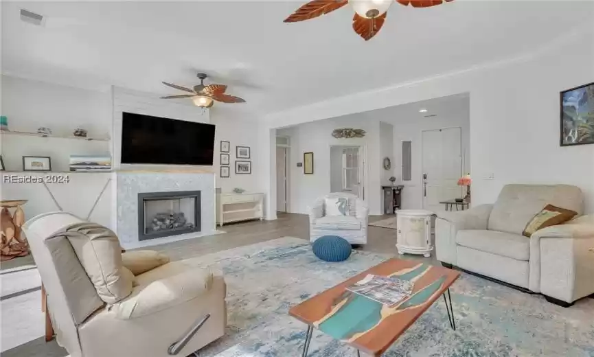 Custom gas fireplace with marble surround, shiplap wall and live edge mantel and shelves.