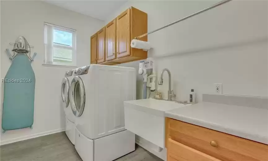 Laundry with utility sink and added cabinets