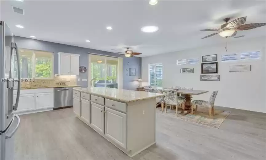 Kitchen/Dining area with sliders going out to screened heated pool.