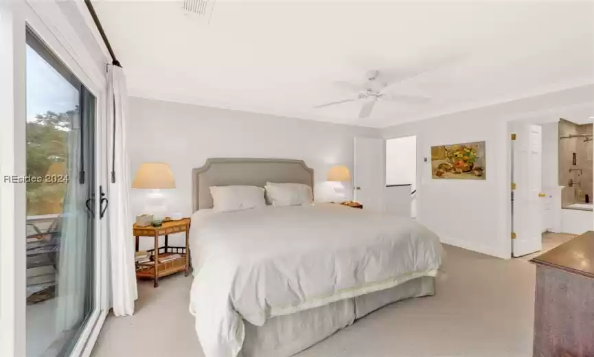 Carpeted bedroom featuring crown molding, ceiling fan, and access to outside