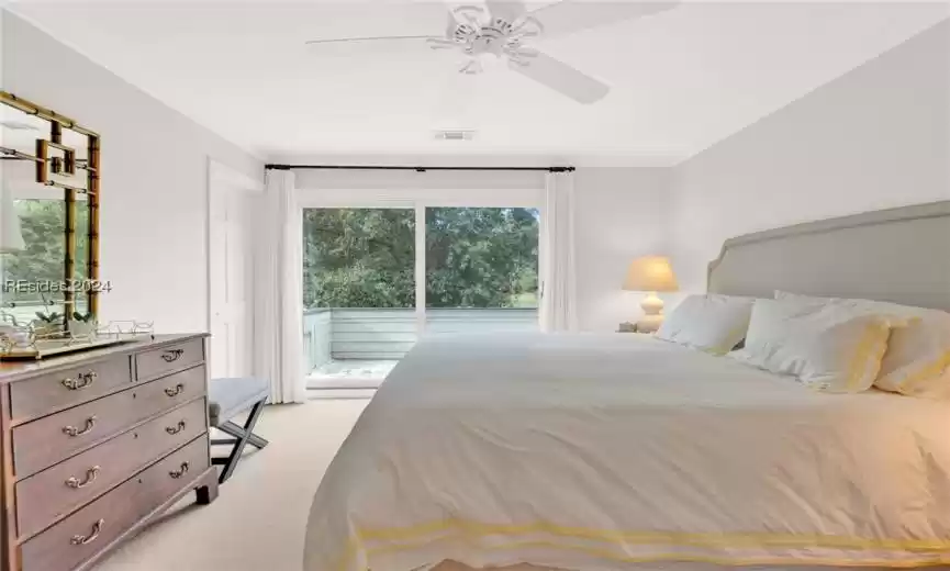 Bedroom with crown molding, light carpet, ceiling fan, and access to exterior
