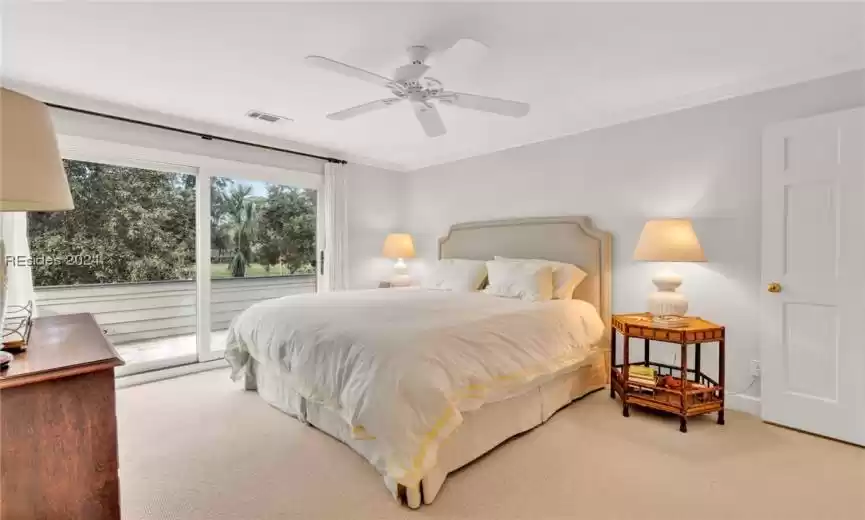 Carpeted bedroom with crown molding, ceiling fan, and access to outside