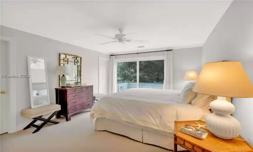 Bedroom featuring crown molding, ceiling fan, light colored carpet, and access to exterior