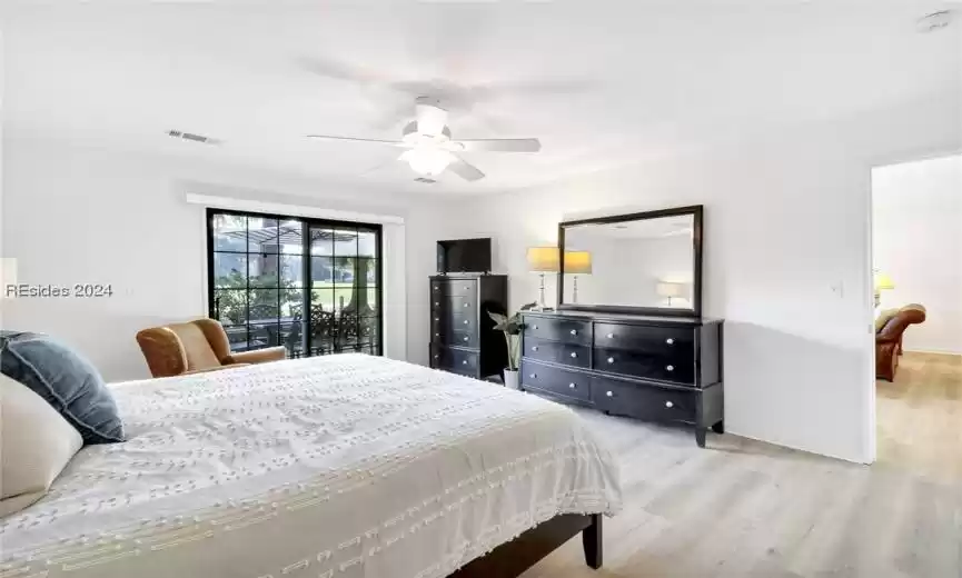 Bedroom featuring access to outside, ceiling fan, and light hardwood / wood-style floors