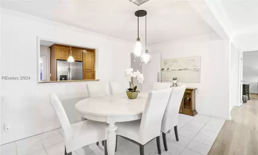 Tiled dining room with ornamental molding