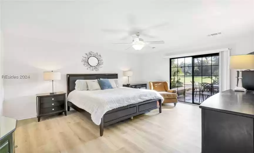 Bedroom with access to outside, ceiling fan, and light wood-type flooring