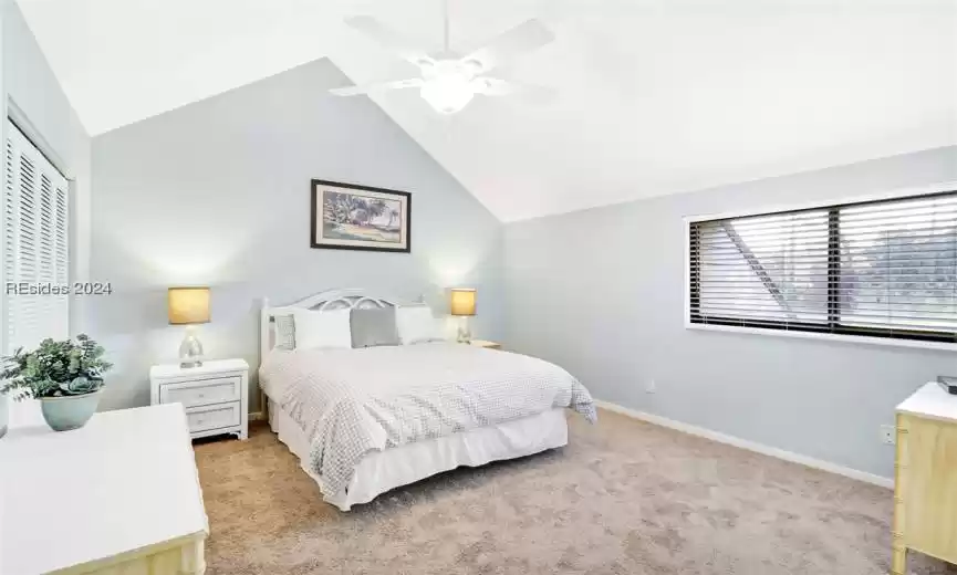 2nd Guest Bedroom with ceiling fan, light colored carpet, and lofted ceiling