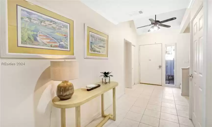 Entryway featuring ceiling fan and light tile floors