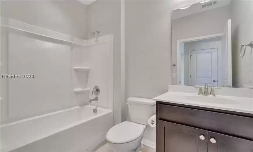 First floor bathroom with vanity, toilet, and  shower combination