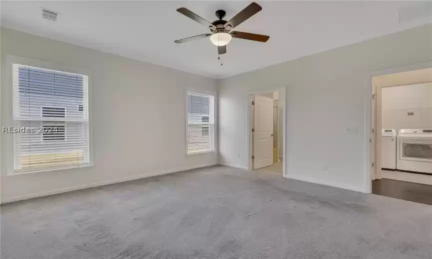 Primary bedroom featuring easy access to laundry room