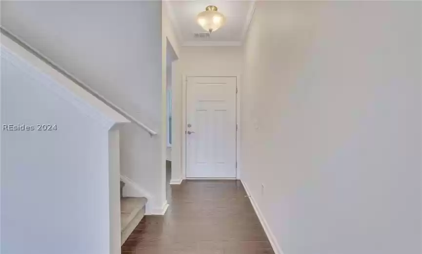 Front entry hallway is adjacent to the office/den and staircase leading to the second floor.