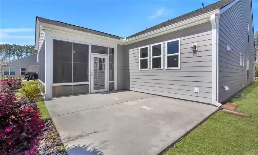 Rear of property with a four season room, and large patio area