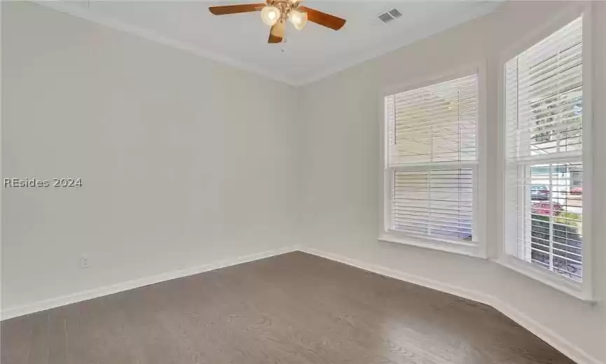 Office/den adjoining the front entry foyer has lighted ceiling fan