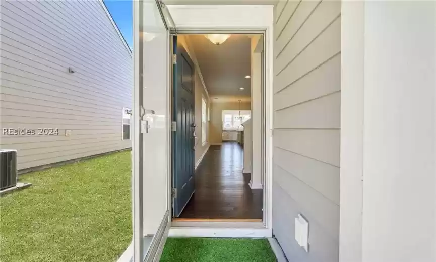 Entry features solid door with glassed storm door