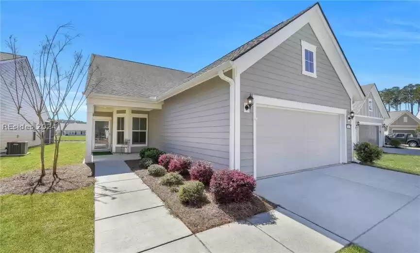 View of front facade featuring a front yard with inviting walkway to porch