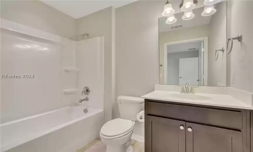 Full bathroom with toilet, vanity, and shower / bathing tub combination