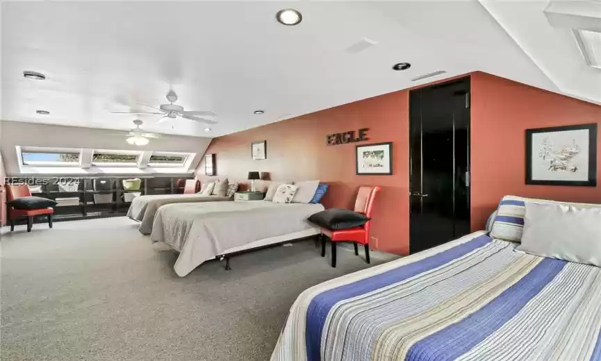 Carpeted bedroom with ceiling fan