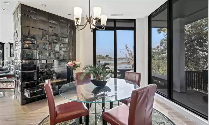 Dining area featuring expansive windows and a notable chandelier