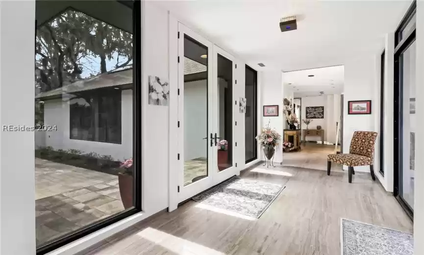 Doorway to outside with french doors and light hardwood / wood-style flooring