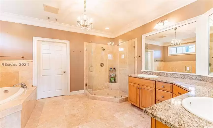 Bathroom featuring vanity, plus walk in shower, a chandelier, ornamental molding, and tile flooring