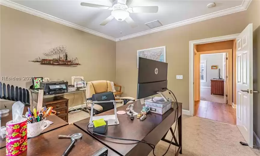 Office featuring light carpet, ornamental molding, and ceiling fan