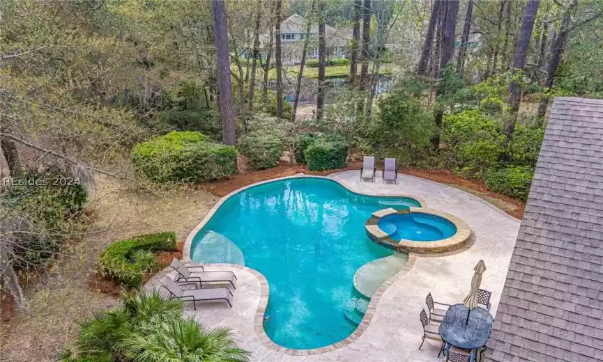 View of swimming pool featuring a patio and an in ground hot tub