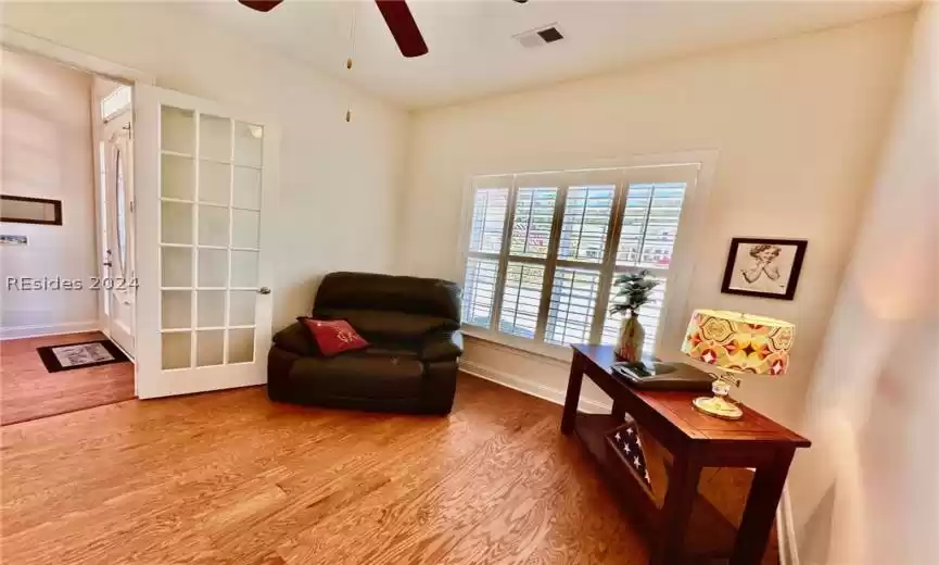 Living area featuring ceiling fan and light hardwood / wood-style flooring