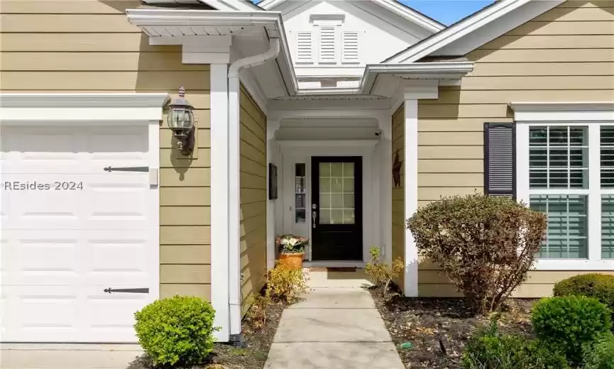View of exterior entry featuring a garage