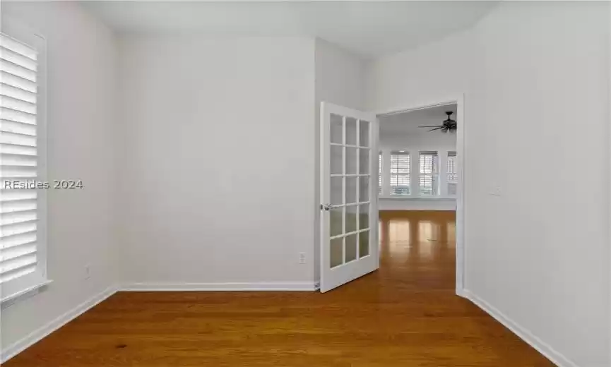 Spare room with dark hardwood / wood-style flooring and ceiling fan