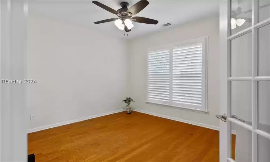 Empty room featuring light hardwood / wood-style floors, french doors, and ceiling fan