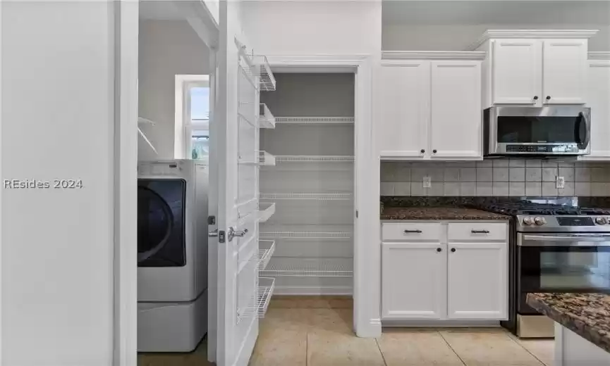 Pantry featuring washer / clothes dryer