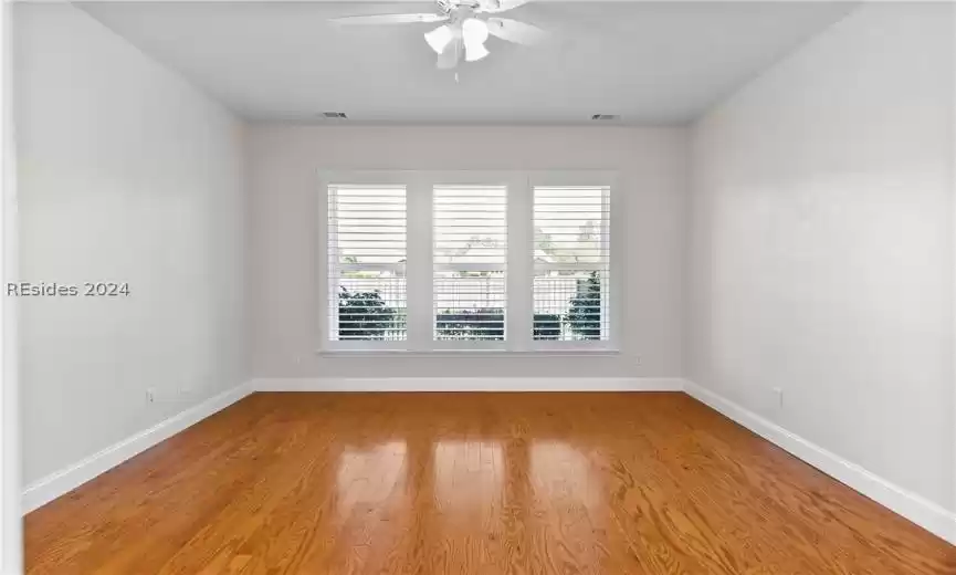 Unfurnished room with light wood-type flooring and ceiling fan
