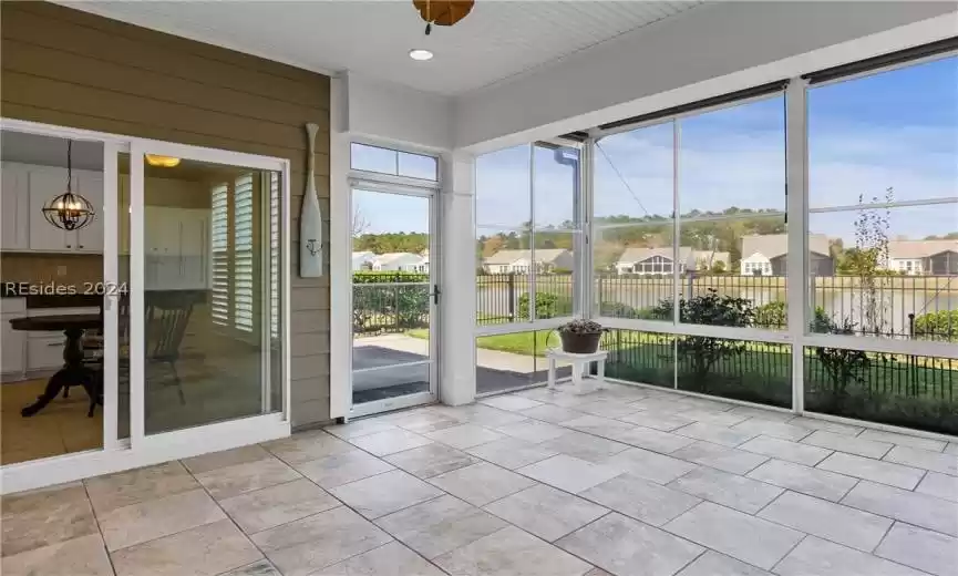 Unfurnished sunroom with a chandelier